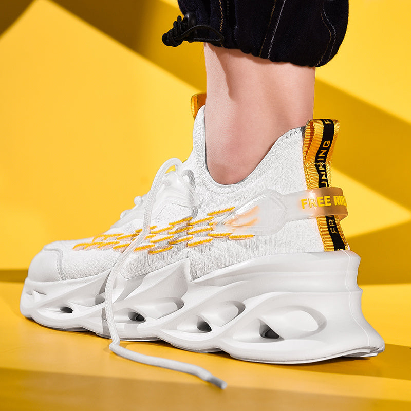 Beige/tan sneaker with unique scale-like texture on sides, chunky sole with cut-outs, and lace-up closure. Features breathable mesh upper and athletic design.